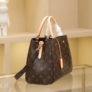 Alternative view of The Montaigne Medium handbag, named after Paris's elegant boulevard, reinterprets practicality with a modern twist. Crafted from Monogram canvas, it features a contemporary silhouette ideal for business settings. Secure storage is ensured by pockets and compartments, while the top handle and detachable shoulder strap offer versatile carrying options. Dimensions: 33x23x15 cm.